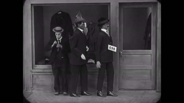 Keaton’s quick motion is the result of a different cranking speed, making it look funnier and less pitiable than his being sent to the back of the line. The flickering associated with older film is an effect of the inconsistent exposure caused by hand-cranking cameras.